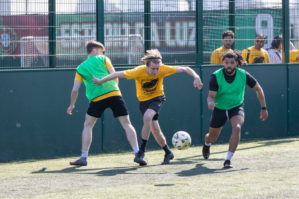 footie players in yellow shirts and green bibs