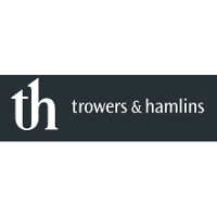 Trowers and Hamlins black and white logo with 'th' at the start